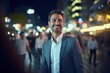 © CYBERUSS - Portrait of Happy Businessman Walking on Street at Night, Handsome European Manager in Modern City Surrounded By Blurred People. Generative Ai