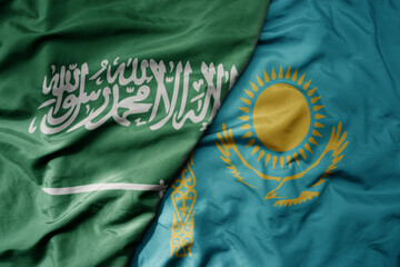 big waving realistic national colorful flag of saudi arabia and national flag of kazakhstan .