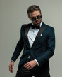© Viorel Sima - fashion young groom with sunglasses looking down and posing