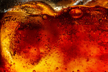 Wall Mural - macro cola drink texture,macro cola background,Background of cola with ice and bubbles. Side view background of refreshing cola flavored soda with carbonated with vintage tone,