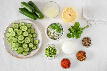 Wall Mural - preparation of cucumber salad with fromage blanc and spices