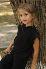 a large portrait of a blonde girl with big eyes and long hair in a black jacket