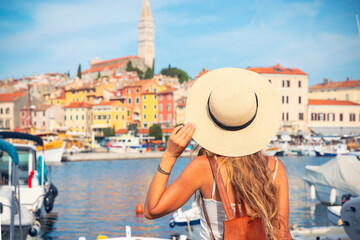 Wall Mural - Rear view of female tourist looking at city of Rovinj in Croatia, Istria- tour tourism,vacation,travel destination-Europa