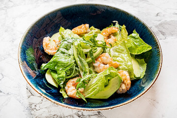 Poster - caesar salad with shrimps  on blue plate