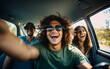 © perfectlab - A young guy takes a selfie while traveling with friends by car