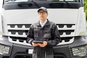 Poster - Manager with a digital tablet next to truck. Fleet management..