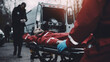 stockphoto, paramedic transporting a victim of a car accident on a stretcher, ambulance in the background. Medical personel on an car crash scene, transporting a traffic accident victim on a stretcher