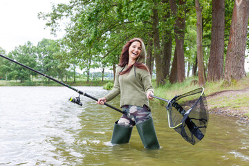 Wall Mural - woman fishing in the river in spring