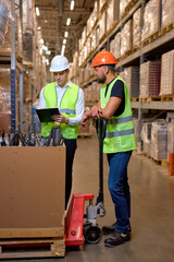 caucasian men warehouse workers with hand pallet jack lift stand having talk, temwork. hand pallet truck and male mover. Workers in uniform with cargo cart. Delivery, logistic and shipping cargo