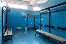 Changing Rooms Of A Swimming Pool With Light Blue Tiles Geometric View Of Benches, Doors And Showers