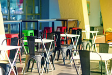 Outdoor Restaurant With Folding Metal Tables And Plastic Chairs
