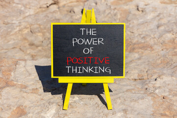 Wall Mural - Positive thinking symbol. Concept words The power of positive thinking on beautiful black chalkboard. Beautiful sea stone beach background. Business, motivational positive thinking concept. Copy space