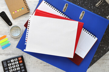 Wall Mural - Flat lay office desk, top view. Workspace with blue folder and red notepad. stationery, open notebook, work desk