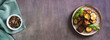 Pieces of fried eggplant with spices and basil on a plate on the table top view web banner