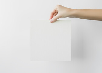 Wall Mural - female hand holds an empty white banner. mockup, space for the text