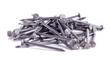 Fototapeta Boho - Pile of small grey metal nails isolated on white background. Close-up