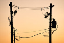 Power Pole Silhouette Of Transmission Lines At Sunset In Alberta Canada.