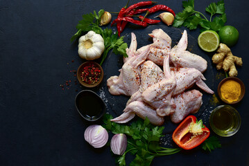 Wall Mural - Raw chicken wings with ingredients for making. Top view with copy space.