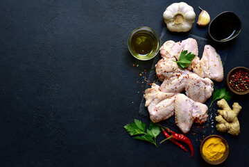 Wall Mural - Raw chicken wings with ingredients for making. Top view with copy space.