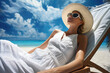 A woman in a beautiful white dress is lying on a deck chair
