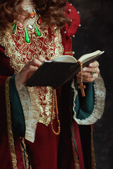 Wall Mural - Closeup on medieval queen in red dress with book and rosary