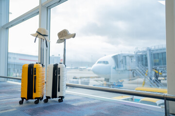 Wall Mural - Two suitcases in an empty airport hall, traveler cases in the departure airport terminal waiting for the area, vacation concept, blank space for text message or design