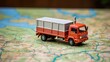 Small toy truck on top of a map to show concept of transport and shipping. generative AI