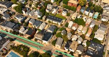 Flight Above The Cozy, Low-rise Houses In The Neighborhood Of Cambridge, Massachusetts, USA. Bright Sunny Cityscape With Plenty Of Greenery From Aerial Perspective.