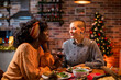 © Marko Geber - Young interracial lesbian couple having a romantic dinner at home during christmas and the new year holidays
