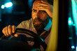 © Marko Geber - Frustrated middle aged caucasian businessman looking at traffic while driving his car at night