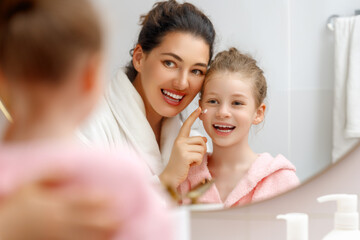 Wall Mural - mother and daughter caring for skin