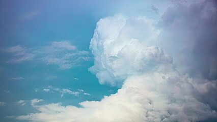 Wall Mural - Amazing timelapse of a huge cloud moving and shifting shapes in the blue sky