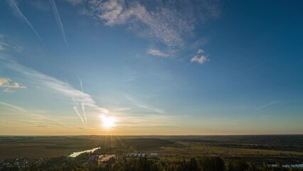 Wall Mural - Sunset timelapse above the valley, view from the mountain. Blue sky with moving clouds. Beautiful landscape, 4k