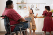 © Wosunan - A plus-size family with a father wearing a prosthetic leg, They happily make breakfast together in the in the kitchen room of the house