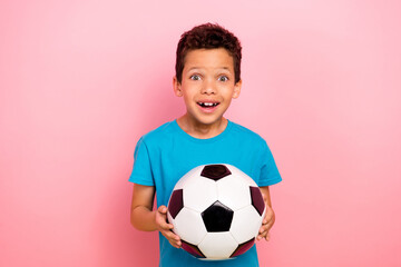 Sticker - Photo portrait of pretty schoolboy excited catch hold football ball dressed stylish blue outfit isolated on pink color background