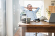 © Westend61 - Happy businessman with hands behind head sitting at desk in home office