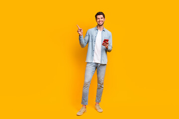 Fototapete - Photo of millennial guy browsing web smart gadget pointing finger empty space ads isolated vivid color background