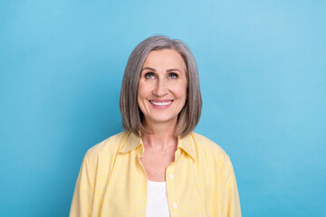 Poster - Photo of good mood sweet lady wear yellow shirt looking up empty space isolated blue color background