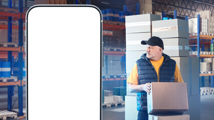 Poster - Man storekeeper. Phone mock up. Warehouse worker with boxes. Smartphone with white screen. Place for ads warehouse services. Phone number for storage company website. Man storekeeper at work