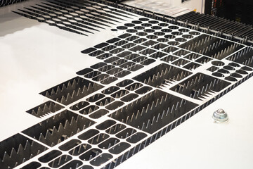 Poster - metalworking industry. sheet of metal on lathe. steel with holes from laser cutting of metal. metalw