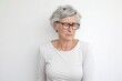 Mature woman with eyeglasses looking at camera over white background