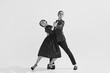 © master1305 - Black and white. Passion and love. Beautiful young woman and man in stylish clothes dancing on white background. Concept of hobby, retro dance, vintage style, choreography, beauty. Monochrome art. Ad