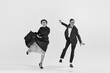 © master1305 - Black and white. Happy, positive, smiling young people, man and woman in elegant clothes dancing lindy hop. Concept of hobby, retro dance, vintage style, choreography, beauty. Monochrome art. Ad