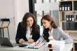 © Nuttapong punna - Two businesswoman discuss investment project working and planning strategy with tablet laptop computer in office..
