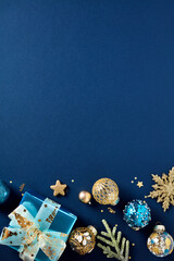 Wall Mural - Christmas vertical banner design, poster mockup, Xmas party invitation template. Luxury gold Christmas balls, stars, decorations, glistering gift boxes on dark blue background. Flat lay, top view