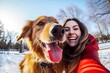 Happy woman takes selfies with her dog in the park in winter time