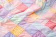 patchwork blanket background in pastel colors
