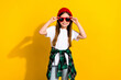 Photo portrait of charming little girl touch sunglass summer vacation wear trendy white garment isolated on yellow color background