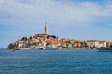 Sticker - View of Rovinj fishing port with colorful architecture and small ships floating on water, Croatia