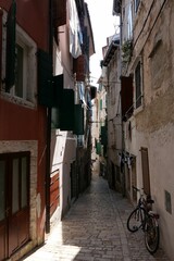 Sticker - Vertical shot of a narrow street with buildings